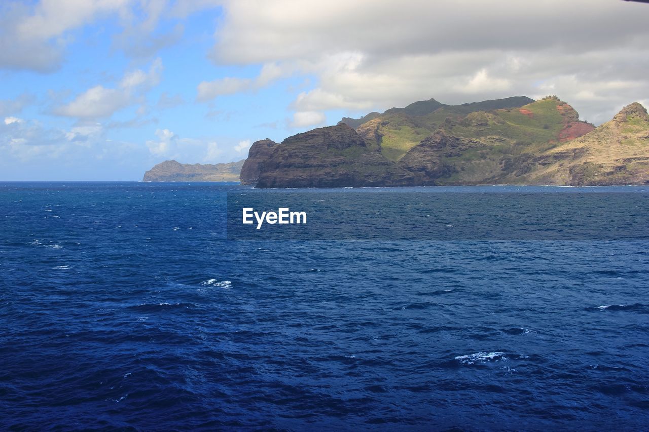 Scenic view of sea against cloudy sky