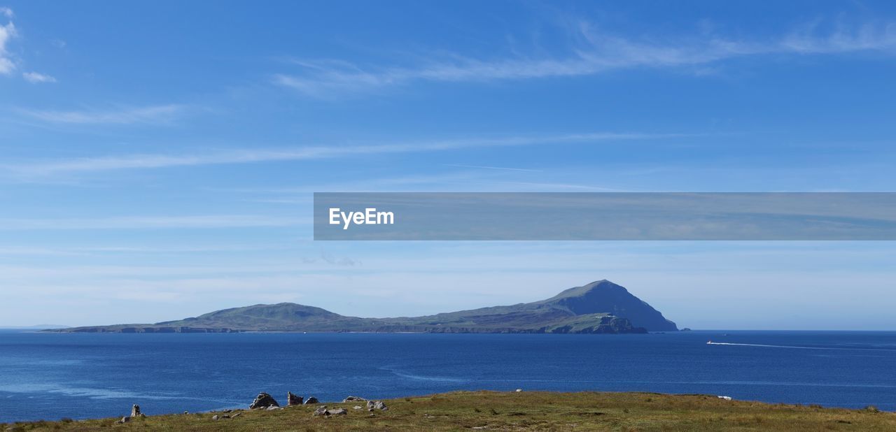 Scenic view of sea against blue sky