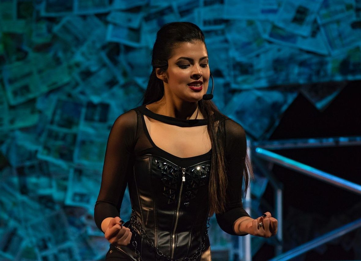 Young woman singing during concert