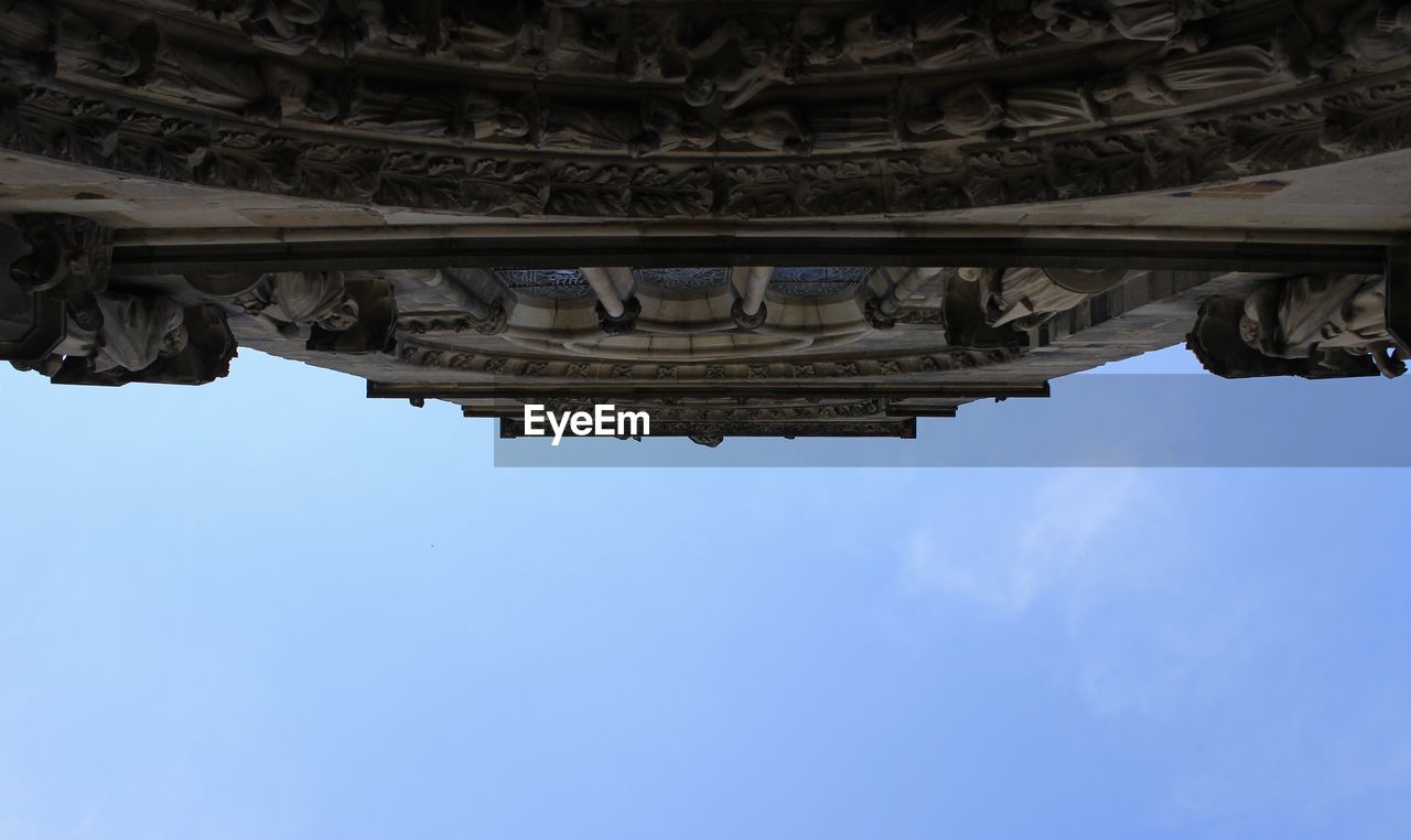LOW ANGLE VIEW OF MONUMENT AND BLUE SKY
