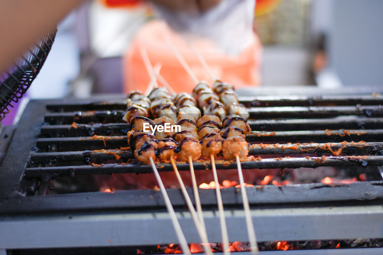 barbecue, food, food and drink, barbecue grill, grilled, meat, freshness, heat, street food, skewer, fast food, cuisine, preparing food, cooking, grilling, day, burning, dish, meal, outdoors, arrosticini, fire, kebab, hand, focus on foreground, close-up, coal, snack, unhealthy eating, summer, one person