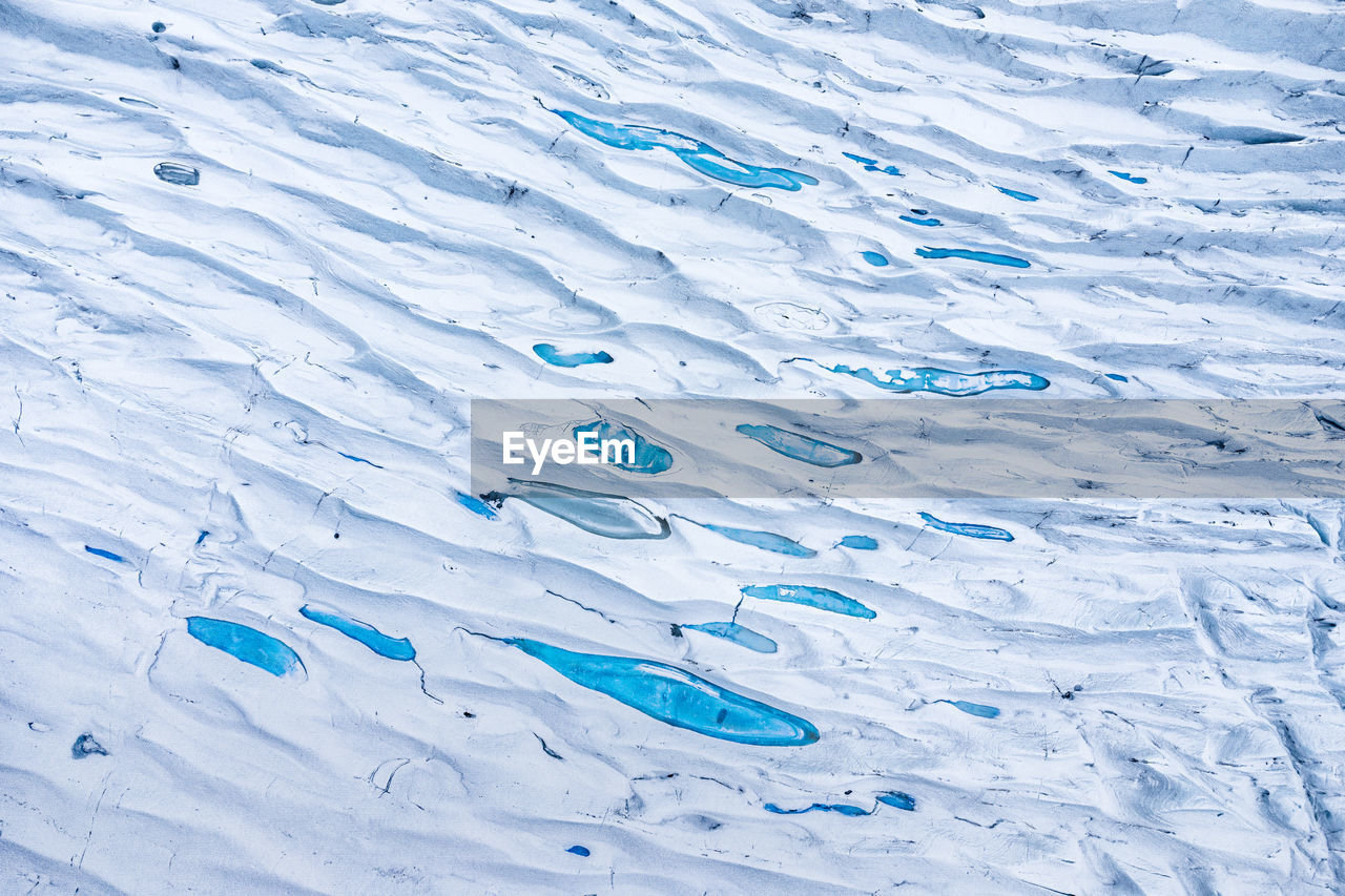 Picturesque scenery of massive glacier surface with shiny blue ice located in vatnajokull national park in iceland