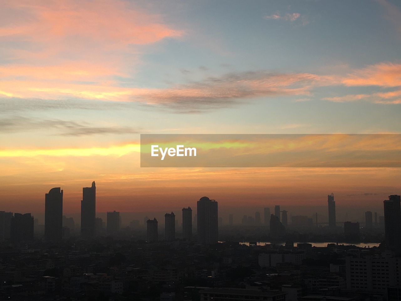 Silhouette buildings against sky during sunset