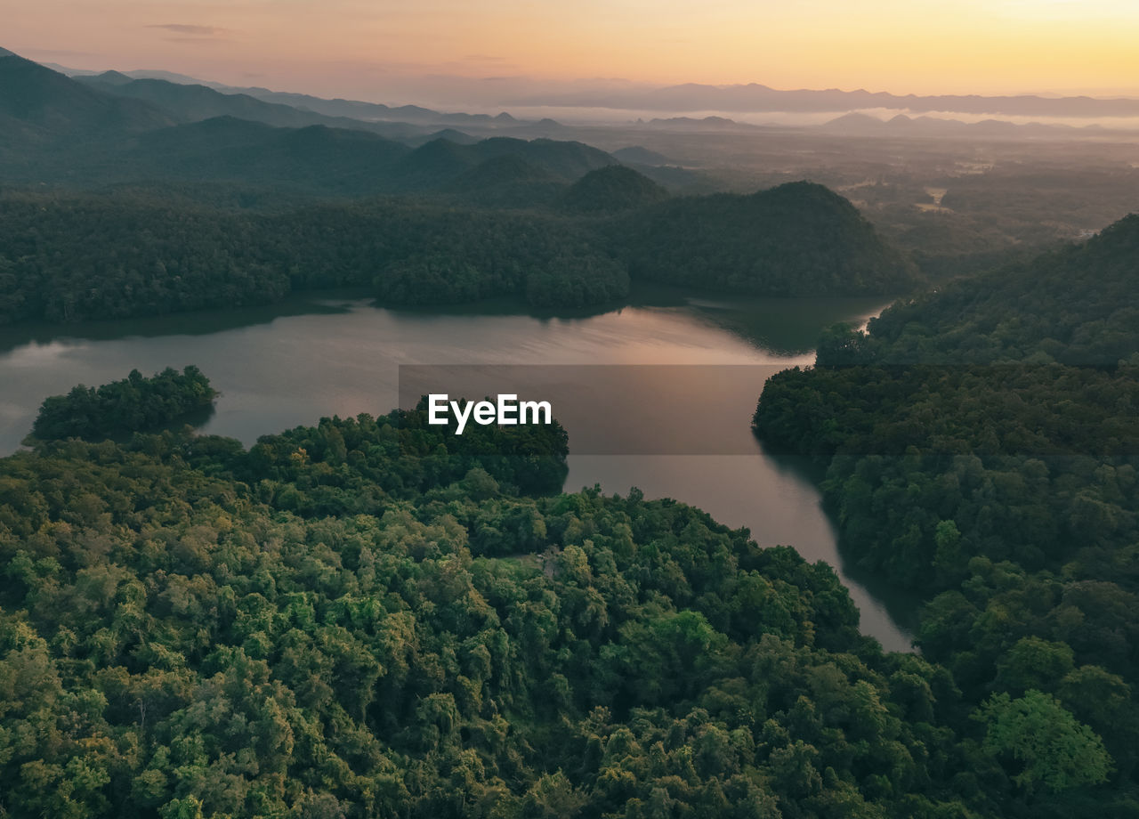 Beautiful landscape of green mountains and lake in the morning with sunrise sky. nature landscape.