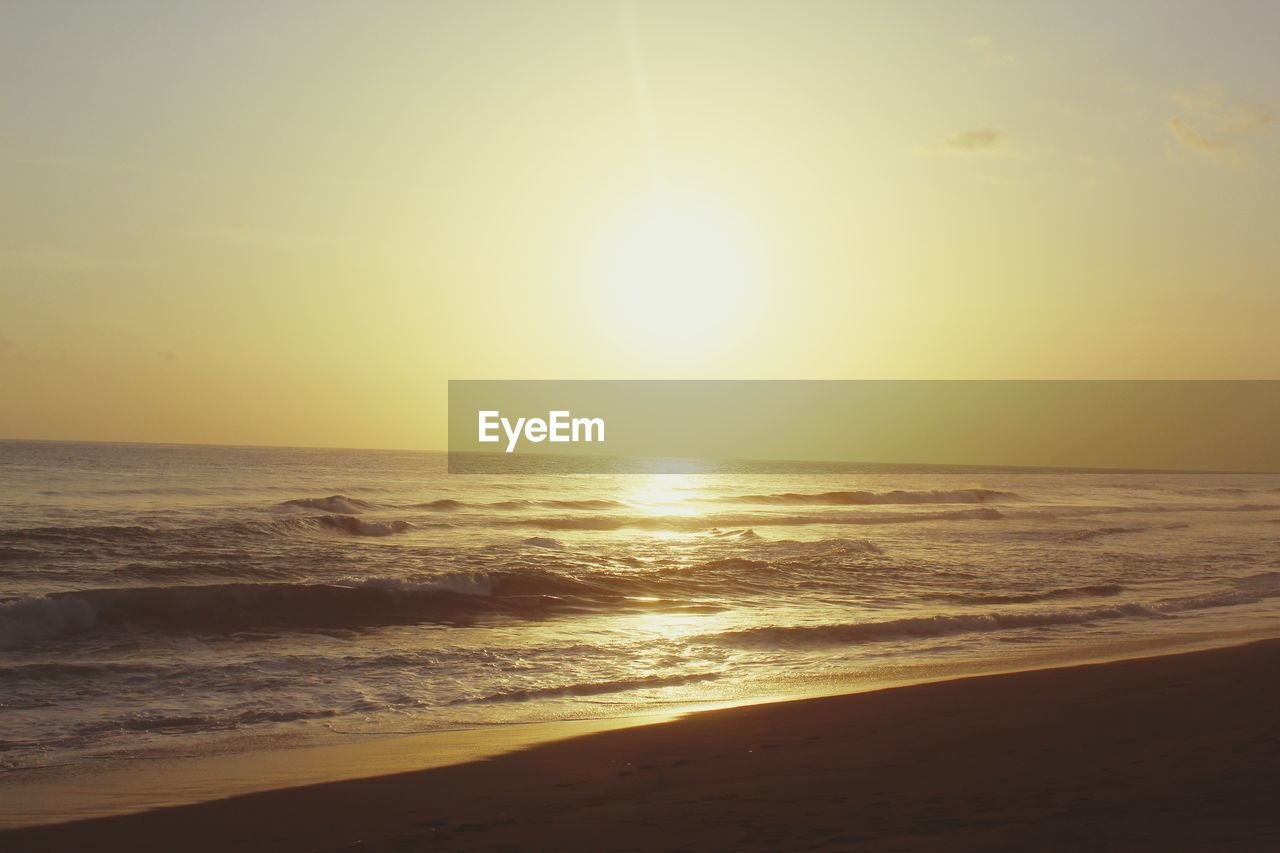 SCENIC VIEW OF BEACH DURING SUNSET