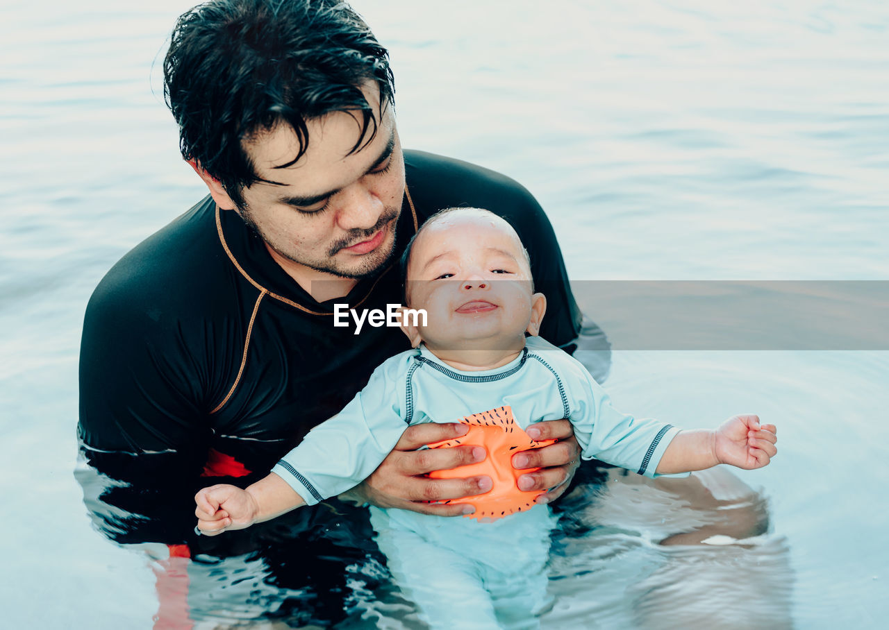 Father with son in swimming pool