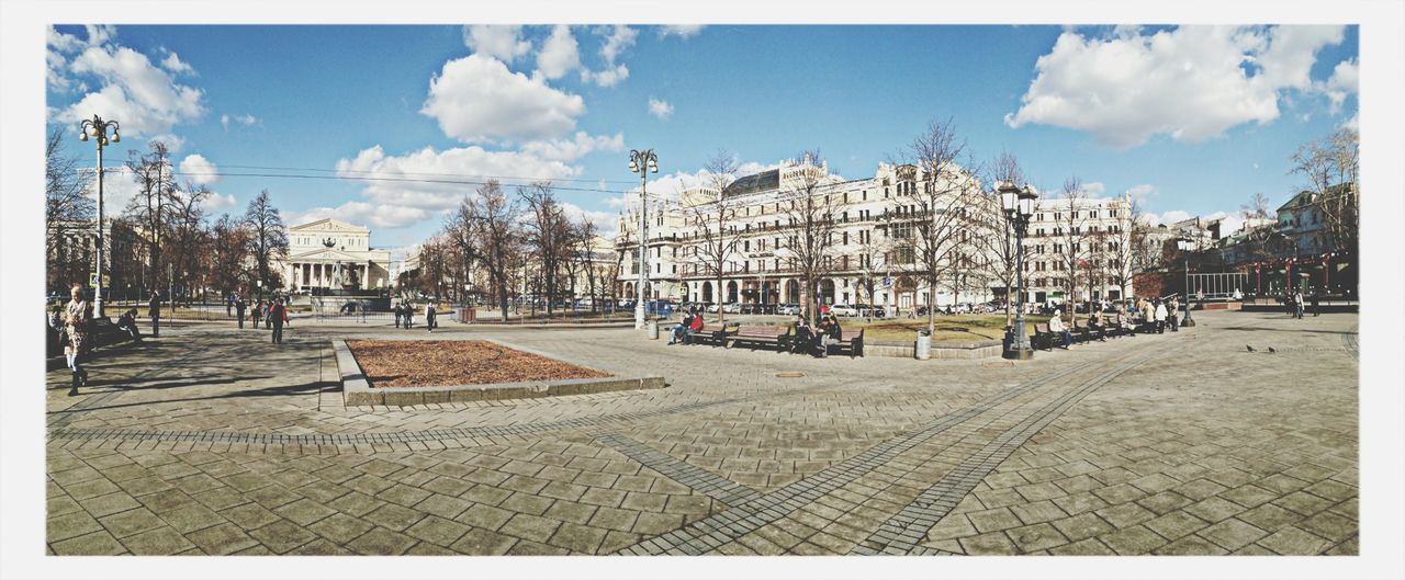 Panoramic shot of buildings at distance against sky