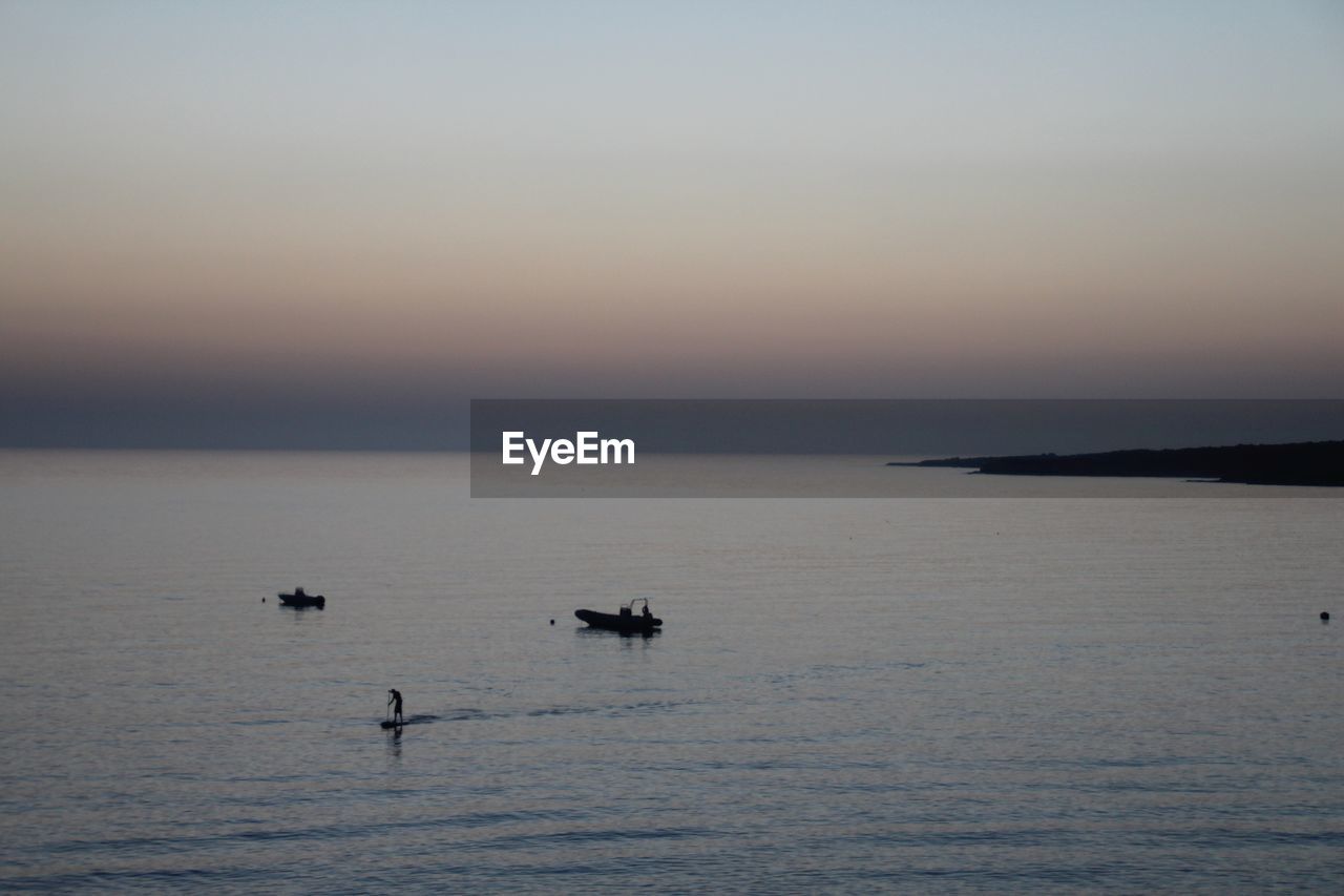 VIEW OF CALM SEA AT SUNSET