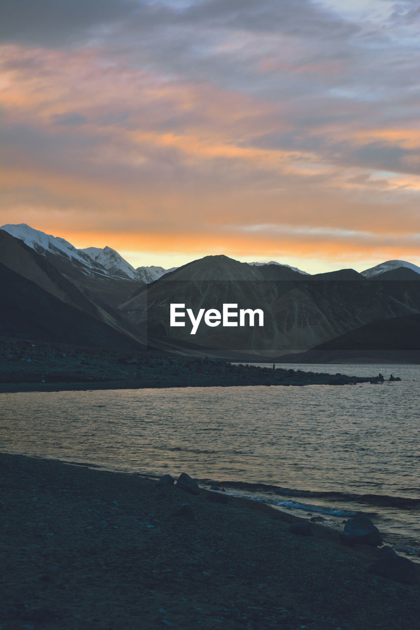 SCENIC VIEW OF MOUNTAIN AGAINST CLOUDY SKY