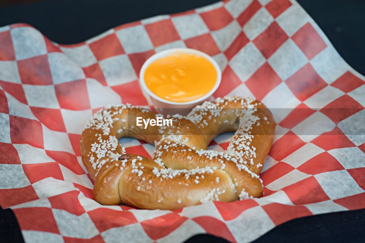 Close-up of pretzel with mustard sauce