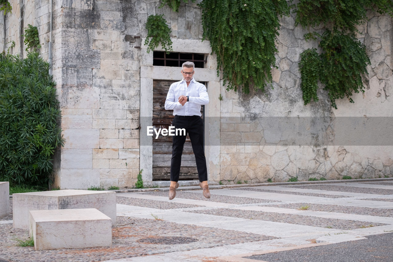 Full length of man standing on footpath