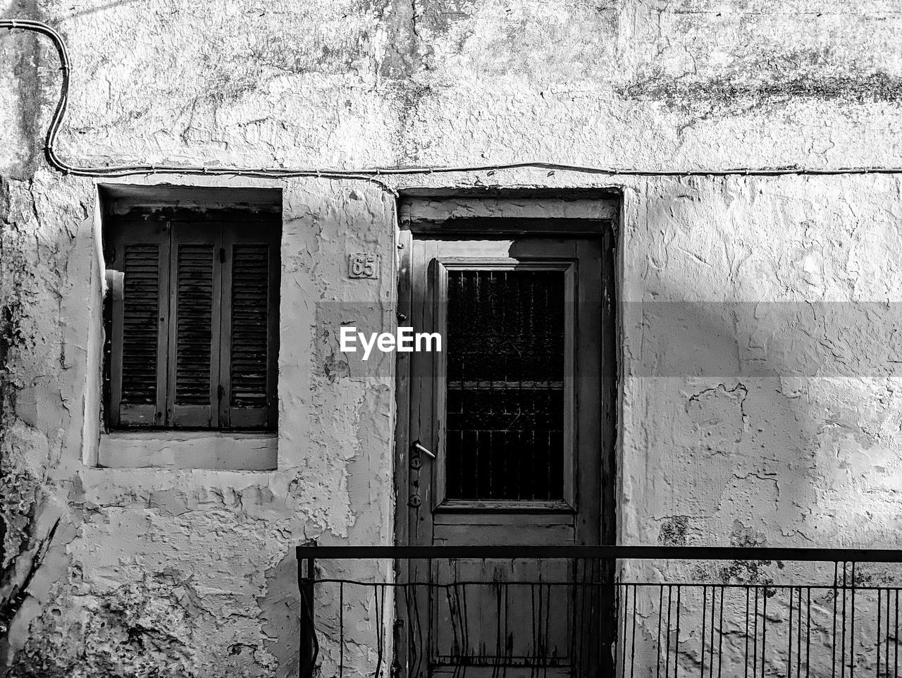 architecture, built structure, building exterior, building, window, black and white, white, house, monochrome, no people, monochrome photography, entrance, door, black, day, wall - building feature, closed, residential district, old, outdoors, abandoned, wall, road, history, street, urban area, home, security, iron