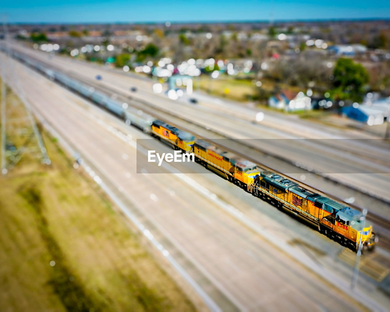 HIGH ANGLE VIEW OF TRAIN MOVING ON HIGHWAY