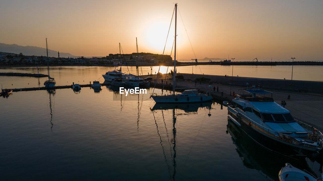 SAILBOATS IN HARBOR AT SUNSET