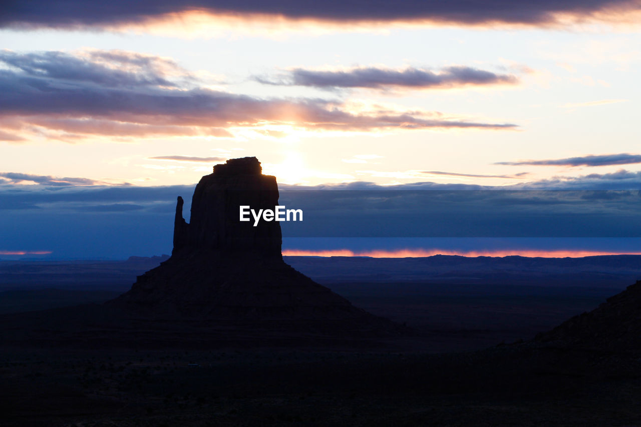 Scenic view of rock formation against sky during sunset