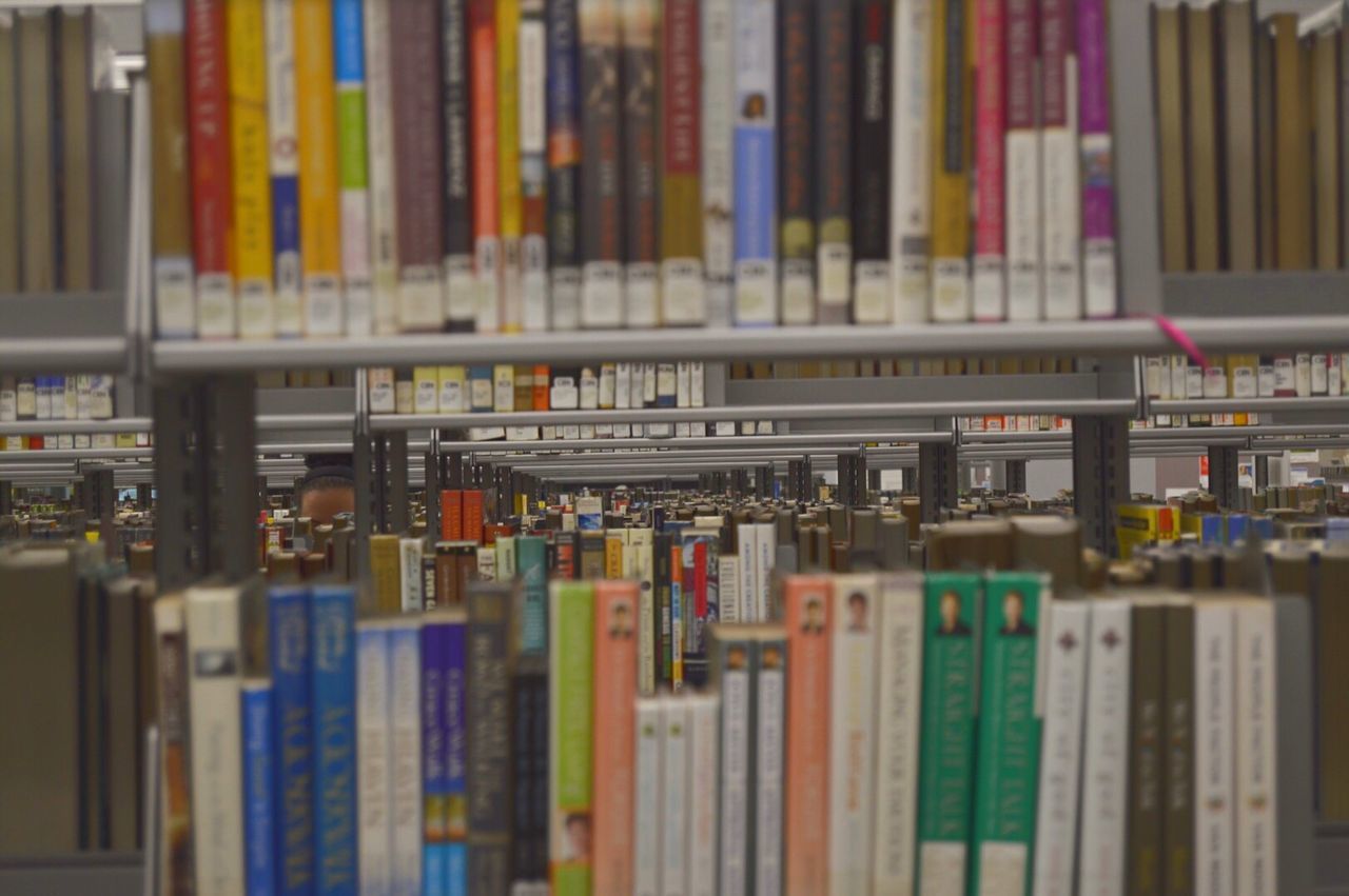 CLOSE-UP OF BOOKS IN SHELF AT LIBRARY