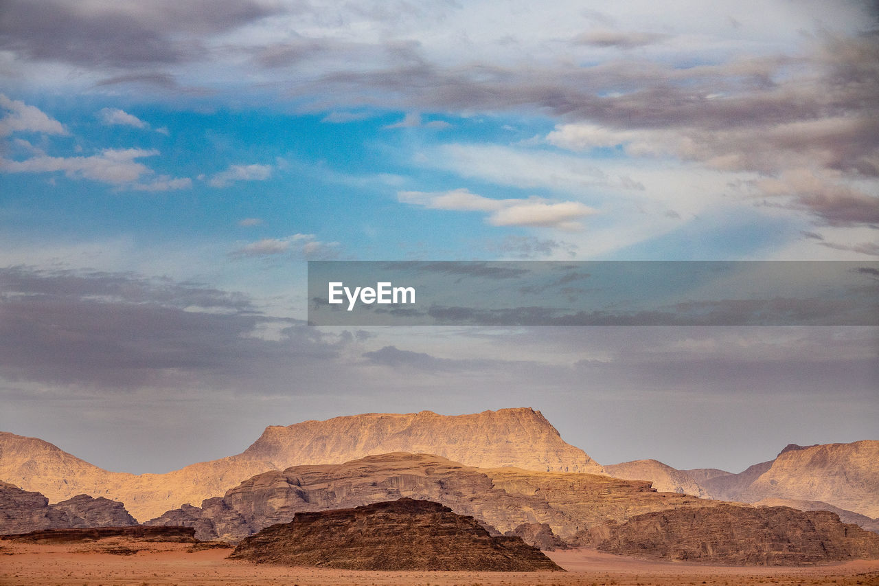 View of mountain range against cloudy sky wadi rum