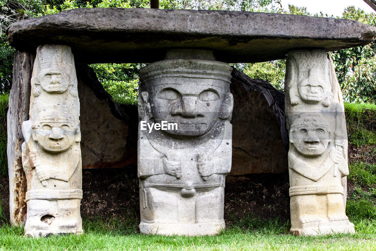 sculpture, art, craft, plant, statue, religion, representation, human representation, architecture, no people, stone material, belief, spirituality, nature, history, day, ancient, creativity, stone carving, the past, monument, outdoors, ancient history, temple - building, grass, travel destinations, male likeness, temple, travel, tree, outdoor structure, built structure, garden, tourism, ancient civilization