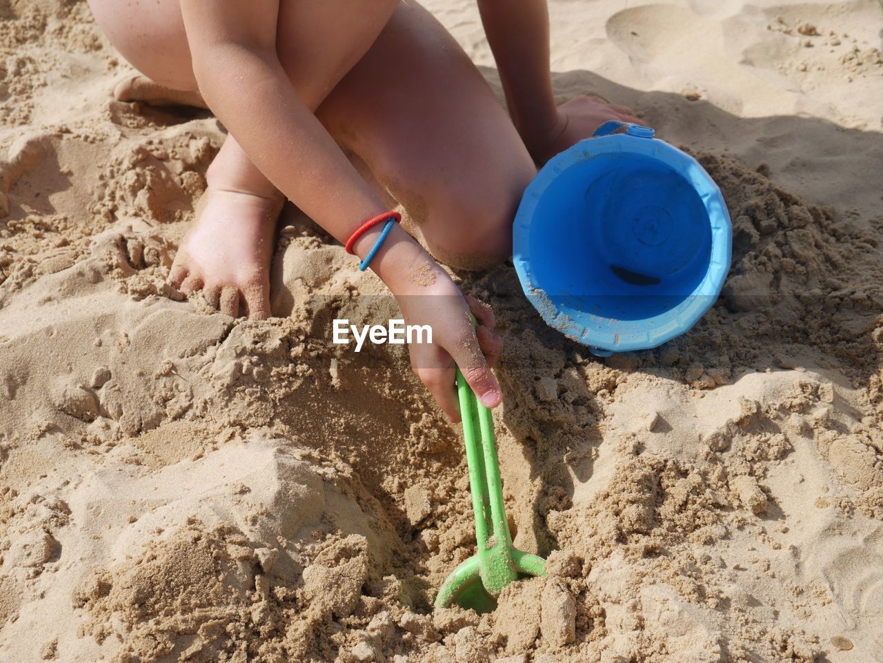 Close-up of a girl playing in the sand