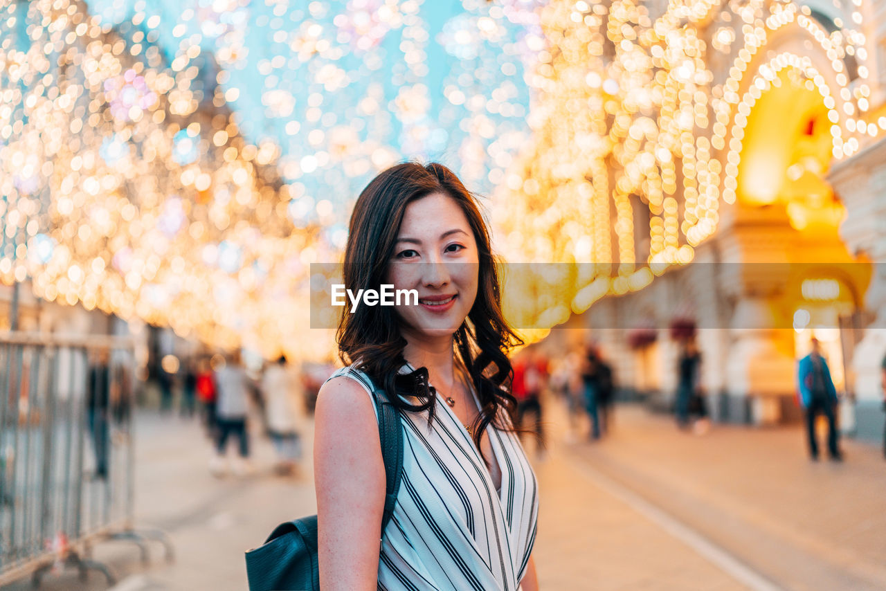 Portrait of smiling woman standing on land