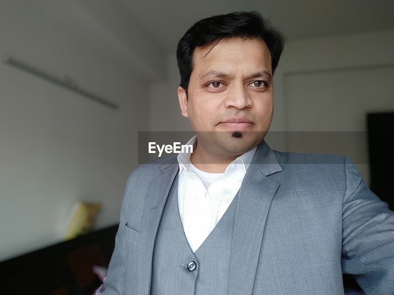 Portrait of businessman standing at home