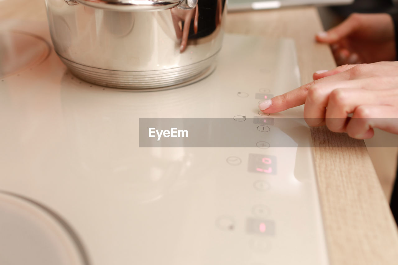 hand, indoors, home appliance, small appliance, one person, domestic room, kitchen appliance, adult, kitchen, domestic kitchen, women, home, close-up, household equipment, domestic life, holding, food and drink, lifestyles, appliance, finger, home interior, selective focus, kitchen utensil