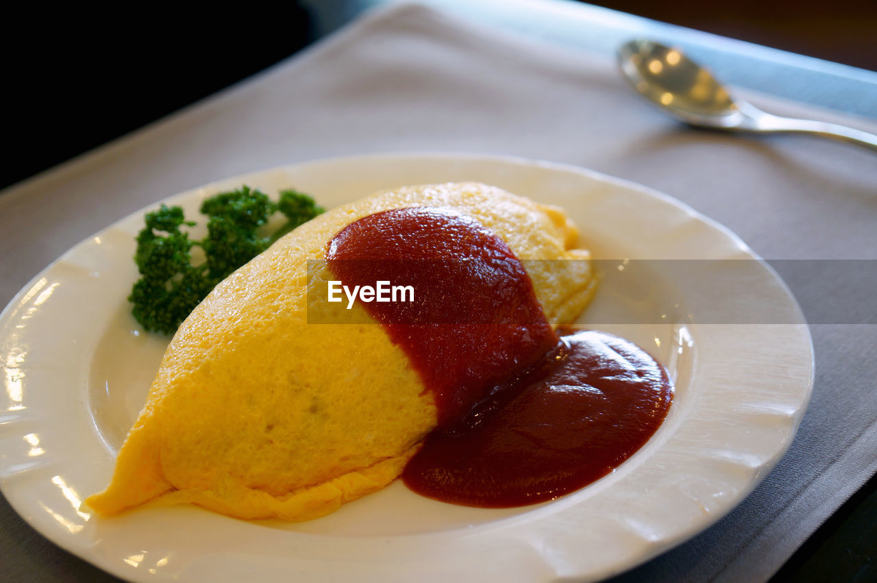 High angle close-up of omurice served in plate