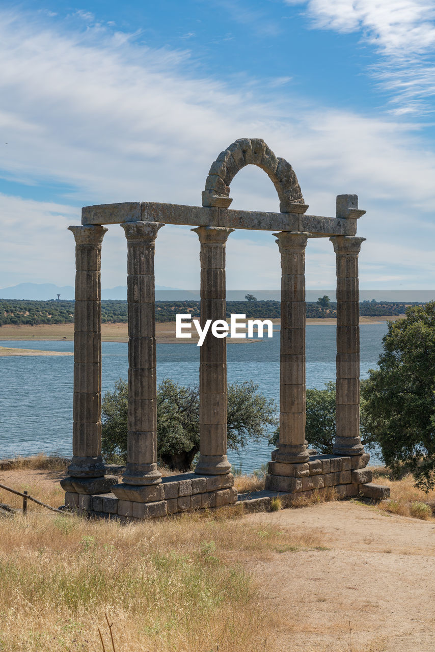 BUILT STRUCTURE ON SHORE AGAINST SKY