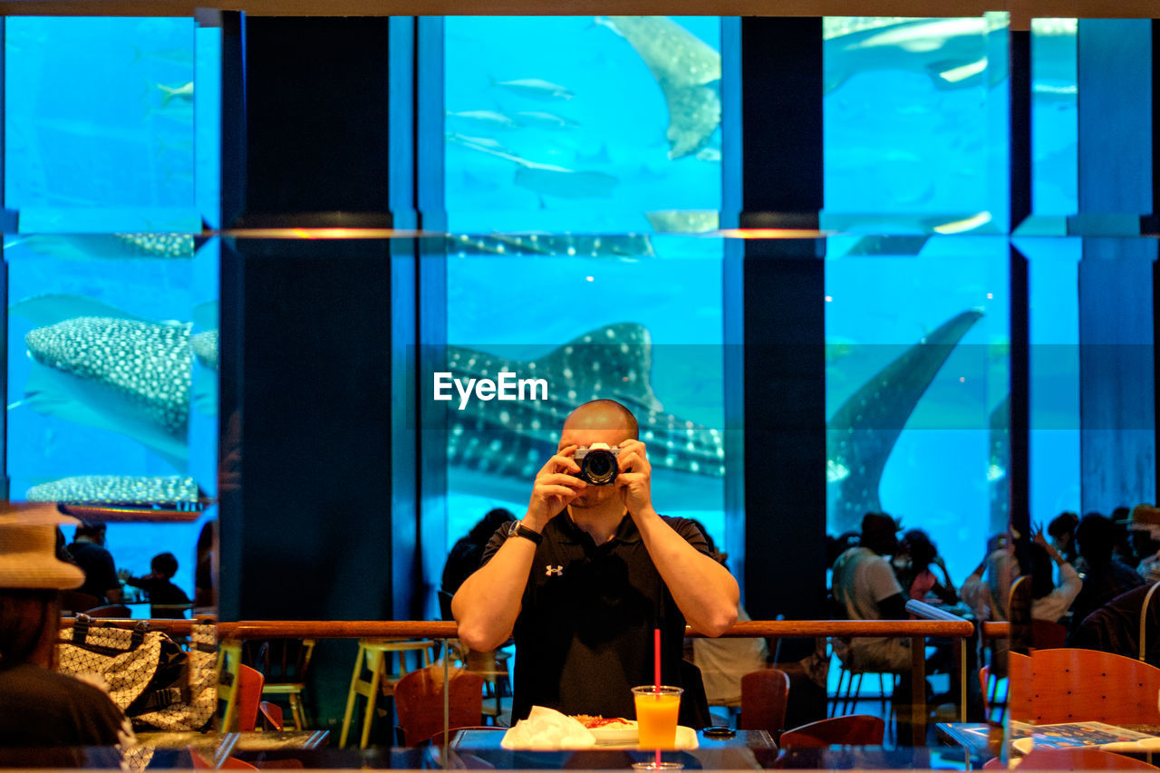 Man photographing at restaurant