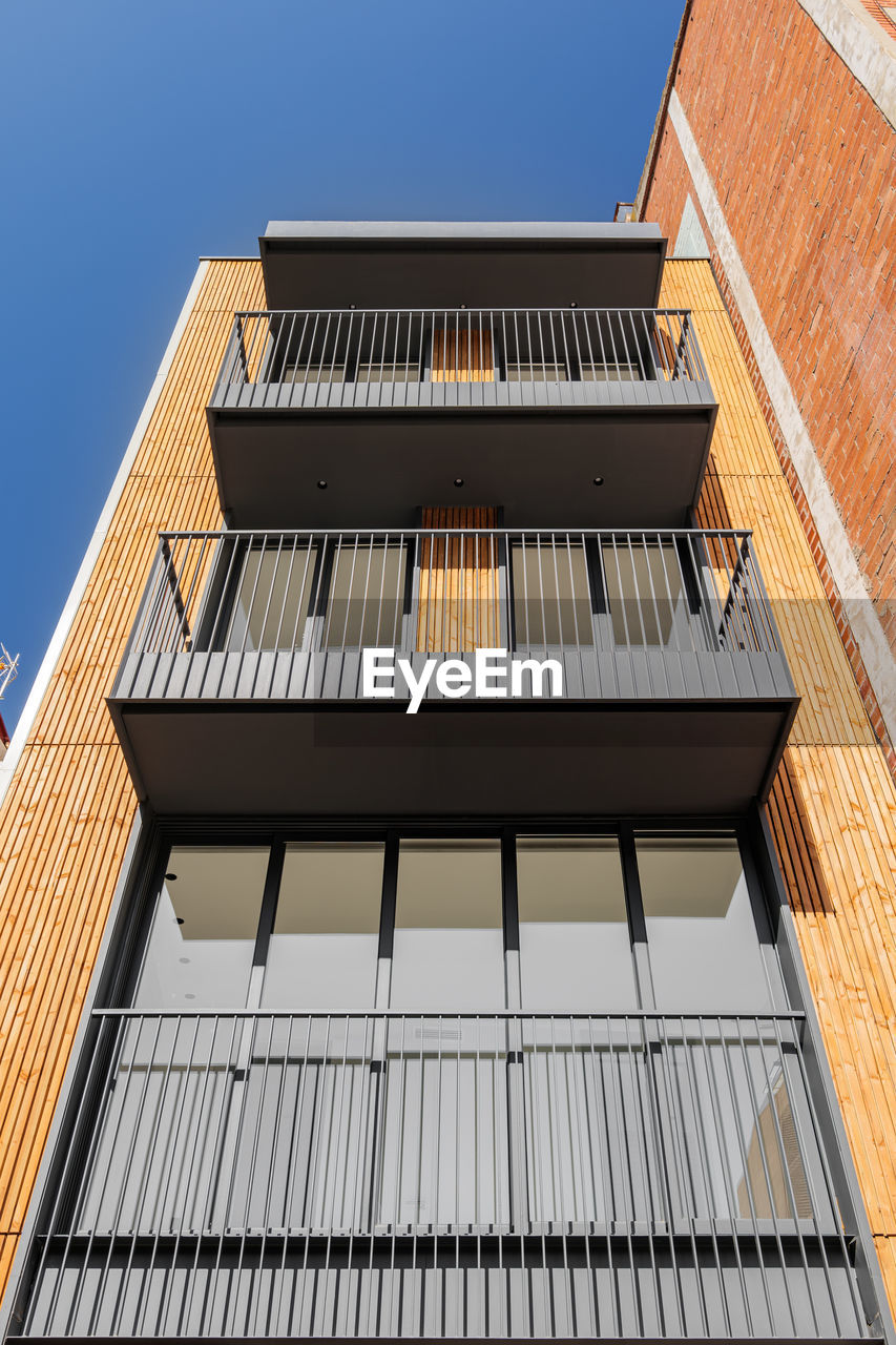 Bottom view of contemporary building facade. outdoor exterior of narrow modern house in barcelona