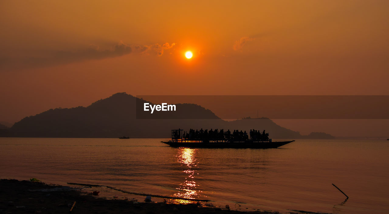 SCENIC VIEW OF SEA AGAINST ORANGE SKY