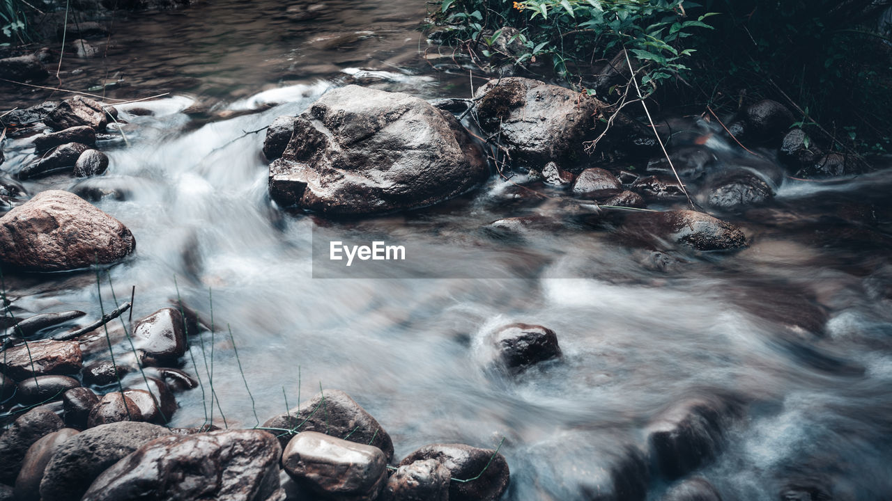 STREAM FLOWING THROUGH ROCKS IN SEA