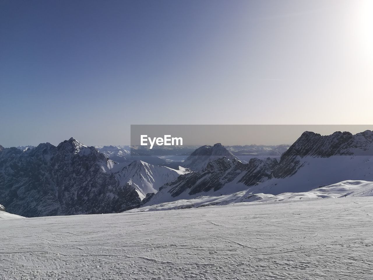 Scenic view of snowcapped mountains against clear sky