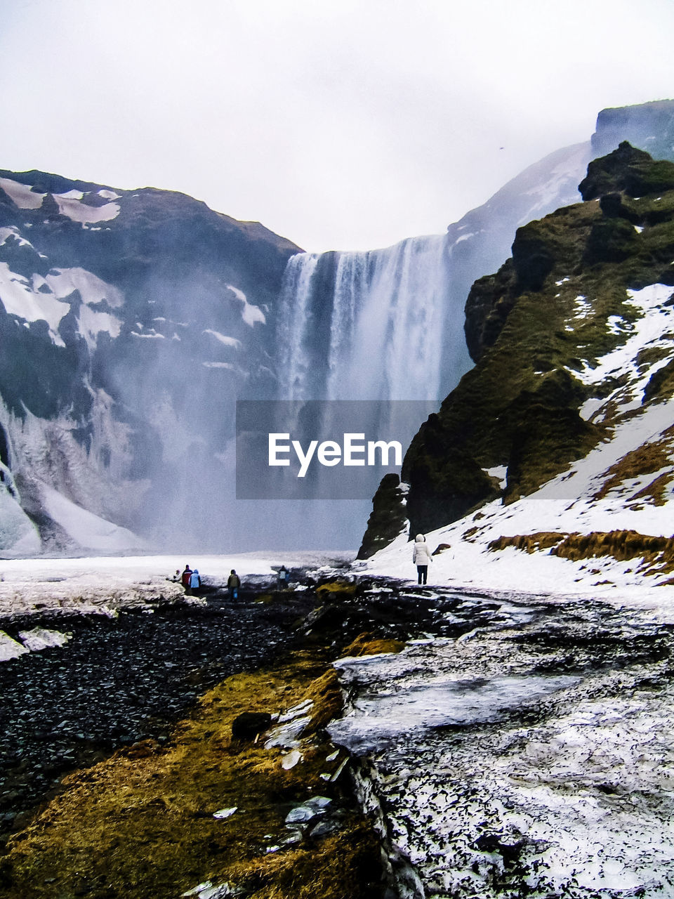 Scenic view of waterfall against sky