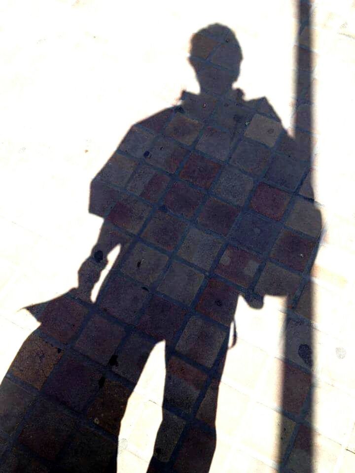 SHADOW OF PERSON ON WALL