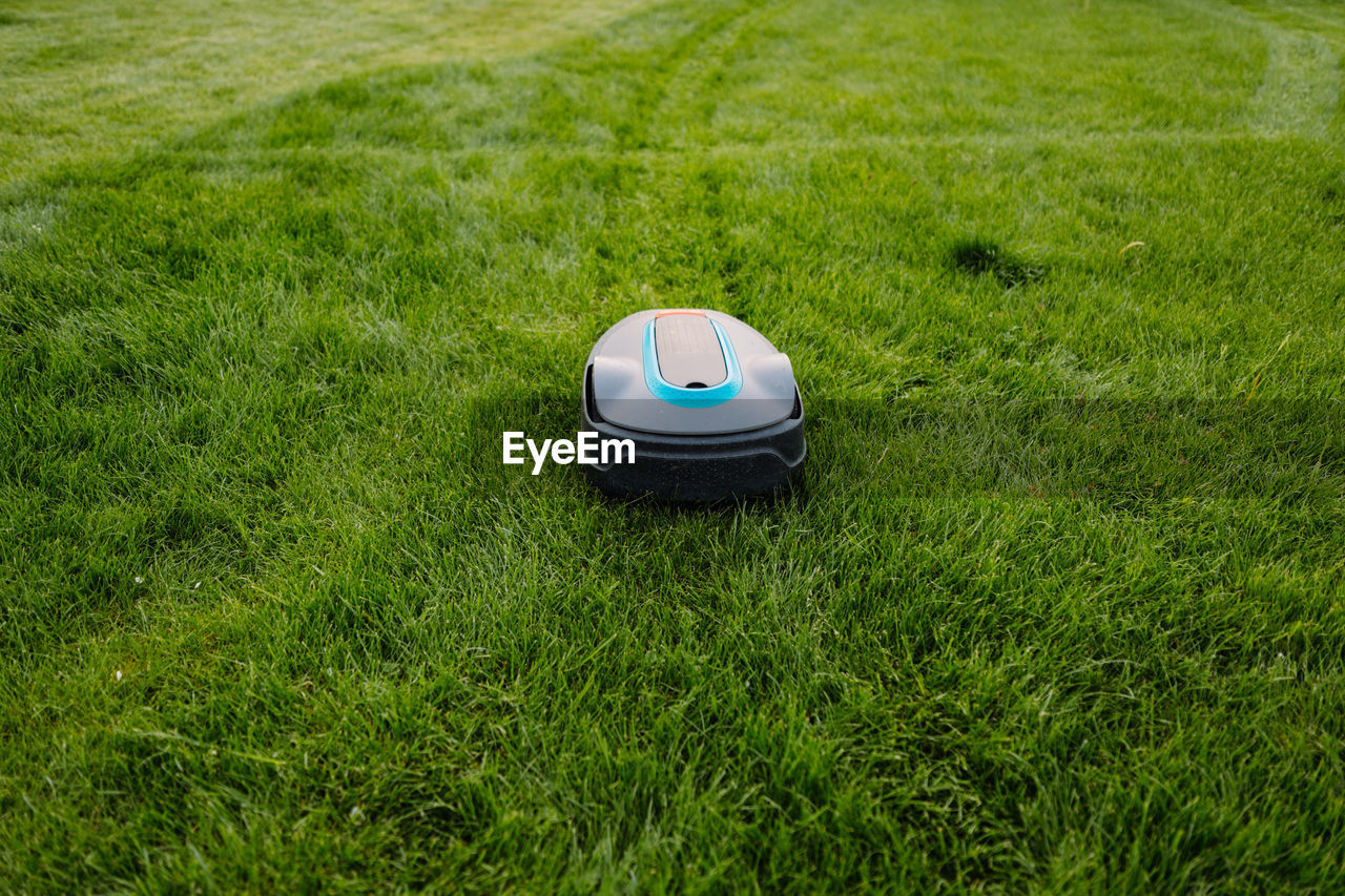 Automatic lawn mower at garden. copyspace. banner photo