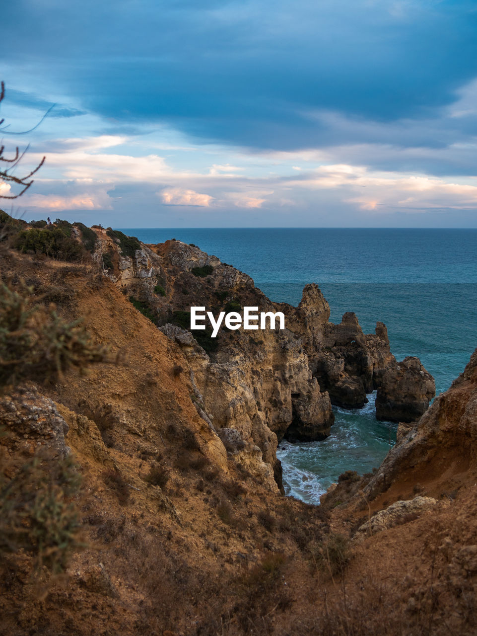 Rock formations on sea shore against sky