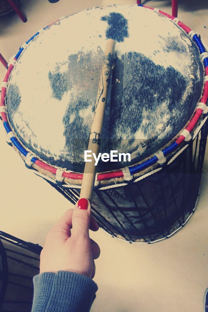 Cropped hand of woman playing drum