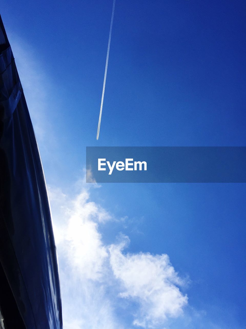 LOW ANGLE VIEW OF VAPOR TRAILS IN SKY