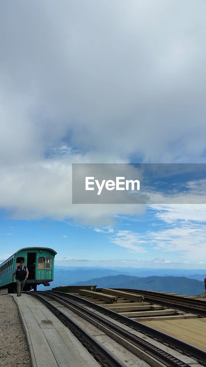 Train on railroad tracks against sky