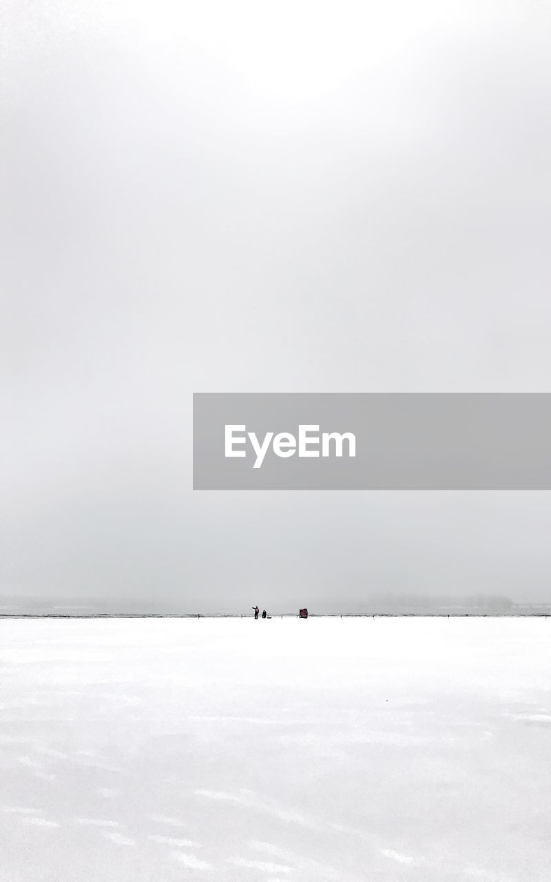 Scenic view of snow covered sea against sky