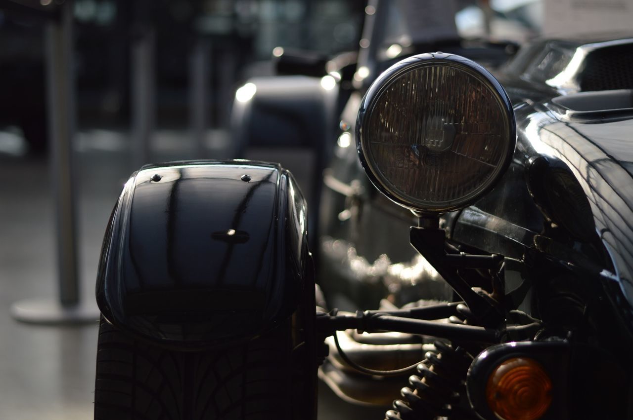 CLOSE-UP OF VINTAGE CAR ON SIDE-VIEW MIRROR