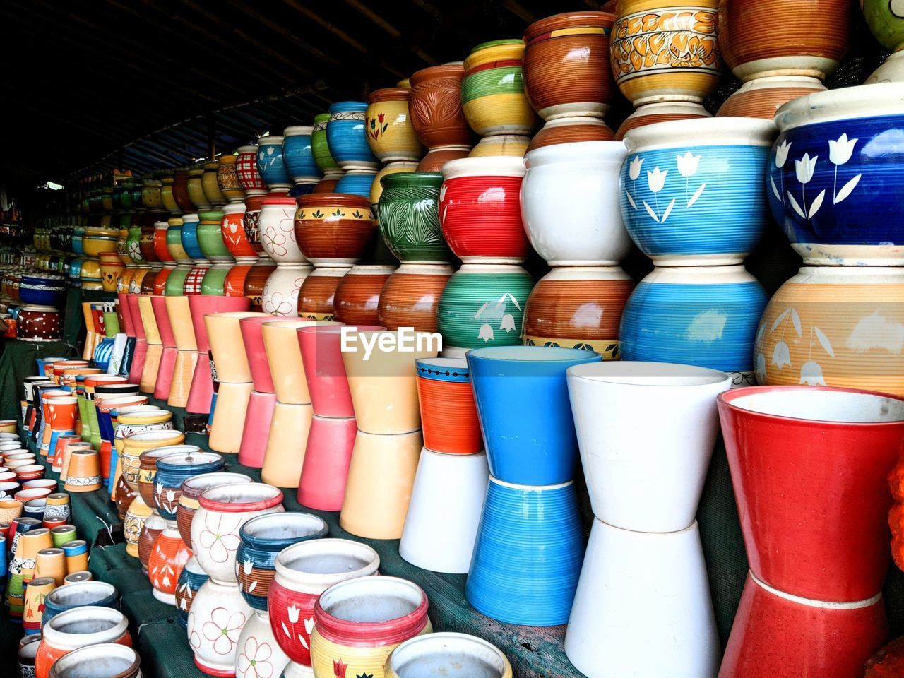 CLOSE-UP OF MULTI COLORED CONTAINERS AT MARKET