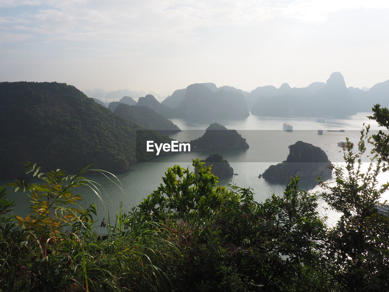 Scenic view of sea and mountains against sky