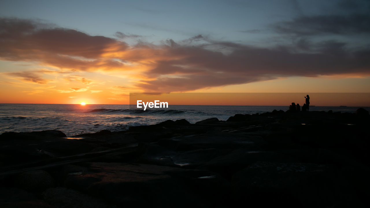 SCENIC VIEW OF BEACH DURING SUNSET