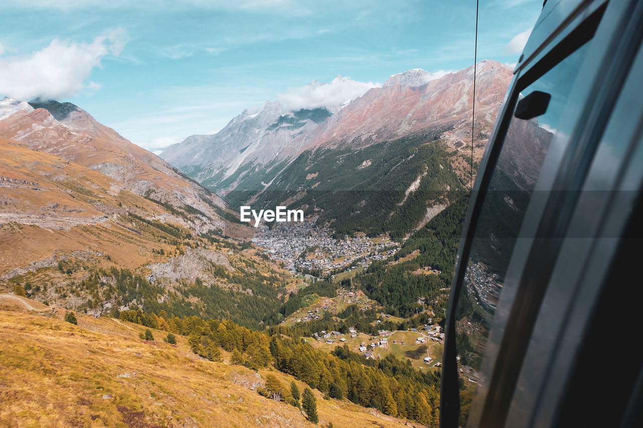 Scenic view of mountains seen through cable car window