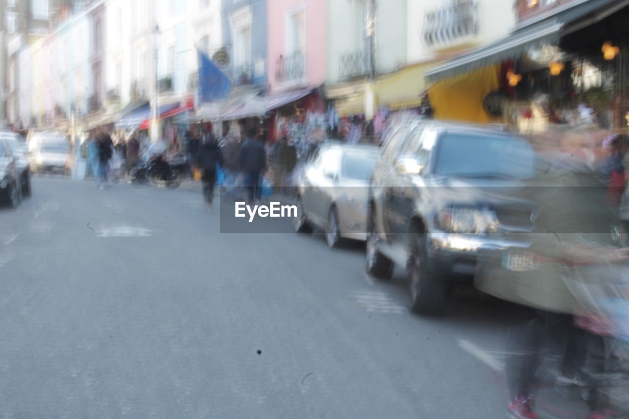 GROUP OF PEOPLE ON ROAD IN CITY