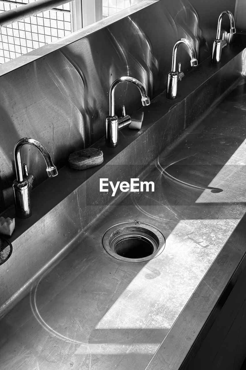 black and white, monochrome, black, monochrome photography, sink, indoors, vehicle, white, no people, room, metal, household equipment, automobile, plumbing fixture, architecture