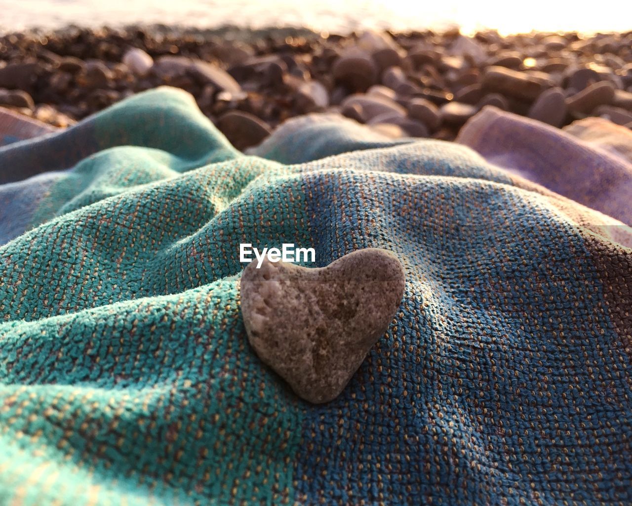 CLOSE-UP OF HEART SHAPE ON ROCKS