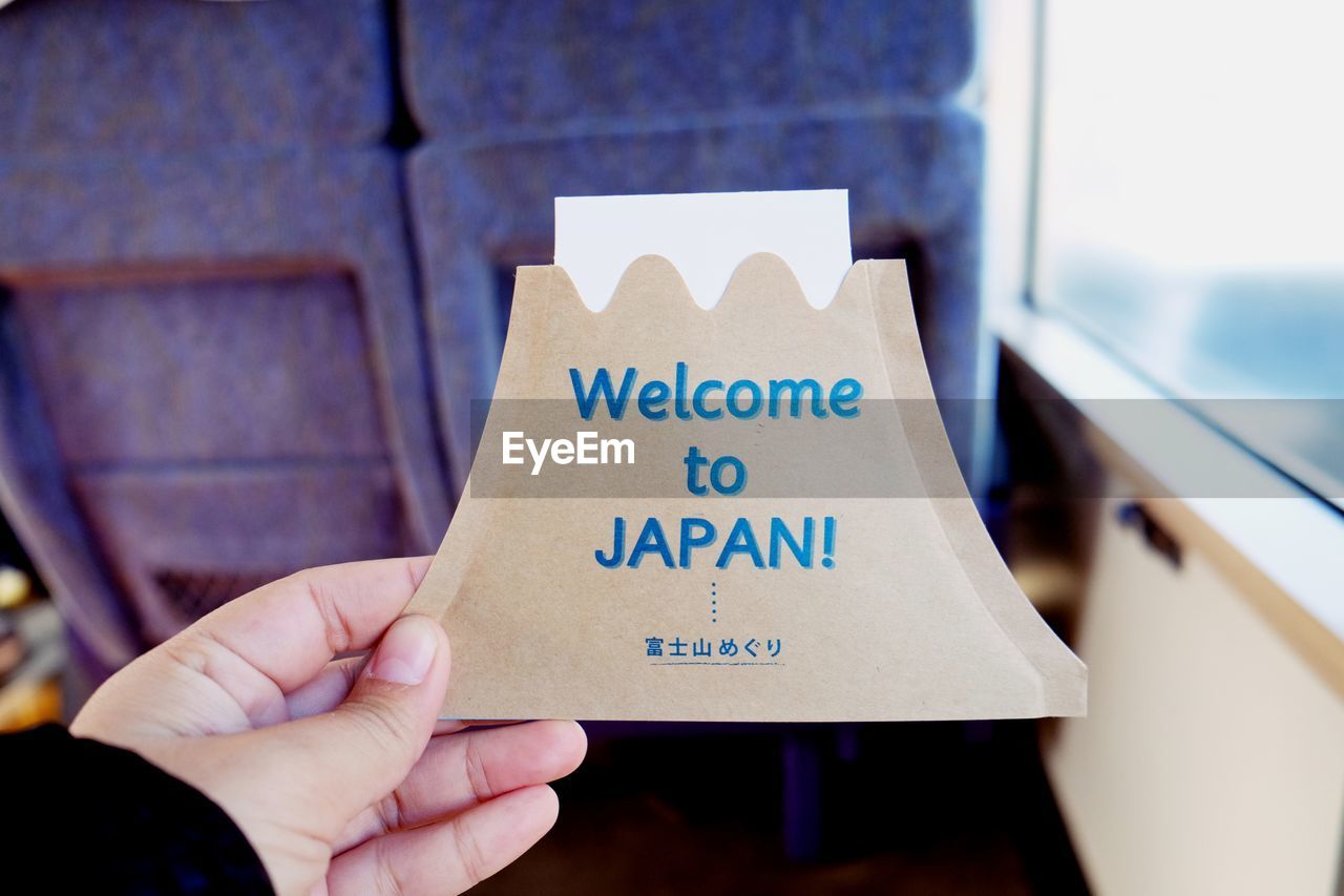 Person holding welcome card on journey